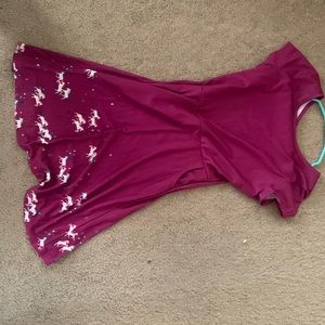 Purple dress with unicorns on the bottom of the skirt